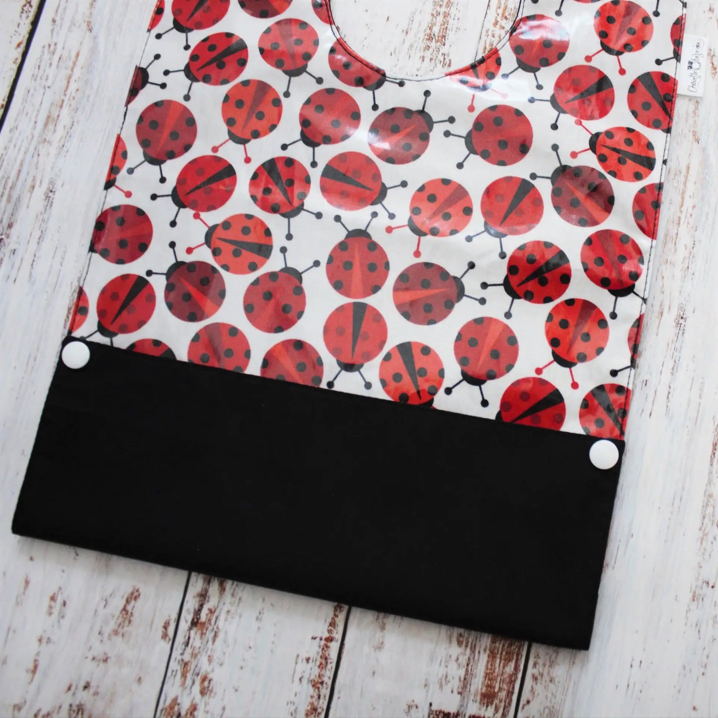 Bavoir en coton laminé – Coccinelles